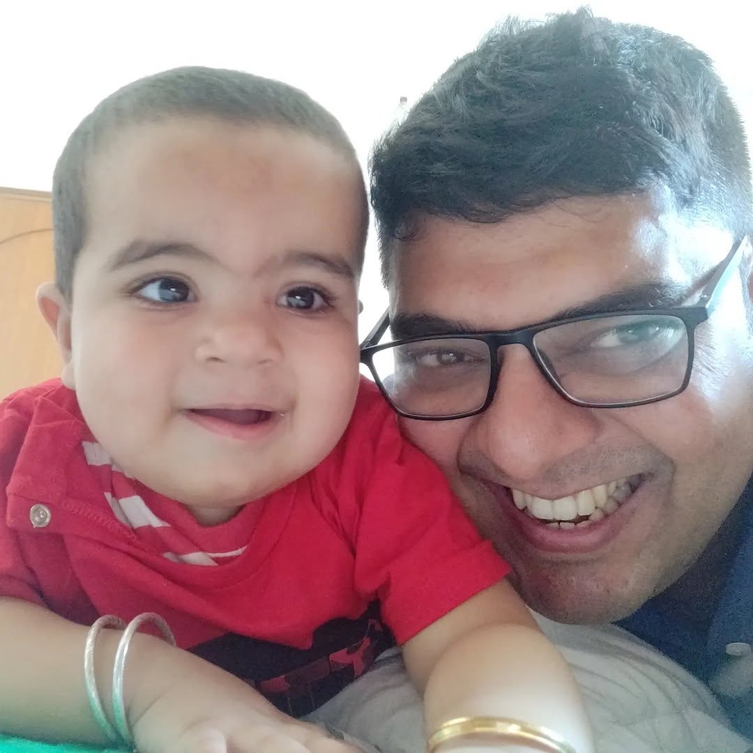Puneet Kaura smiling with his young son